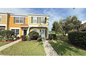 Charming two-story townhome with well-maintained landscaping and a welcoming entryway at 1400 Costa Mesa Dr, Wesley Chapel, FL 33543