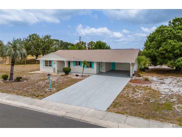 Charming single-story home featuring a long driveway and carport at 1509 Cherry Hills Dr, Sun City Center, FL 33573