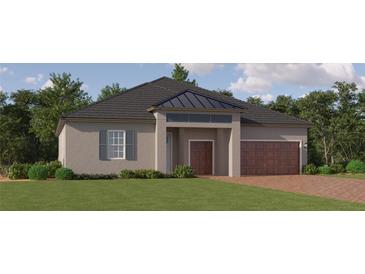 Beautiful single-story home with lush landscaping and a modern design on a sunny day at 16941 Falling Waters Ct, Land O Lakes, FL 34638