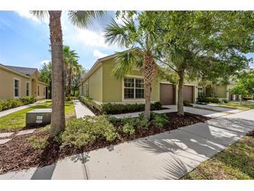 Charming one-story home featuring a well-maintained exterior with two-car garage and tropical landscaping at 1713 Trailwater St, Ruskin, FL 33570
