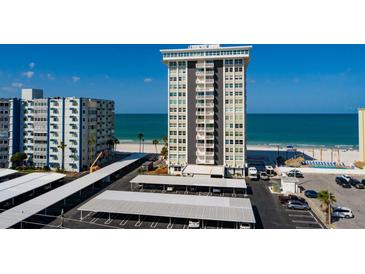 Coastal condominium featuring beach access, covered parking, and partial water views at 17408 Gulf Blvd # 203, Redington Shores, FL 33708