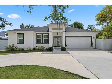 Charming single-story home featuring a well-manicured lawn, driveway, and an attached two-car garage at 19212 Sunlake Blvd, Lutz, FL 33558