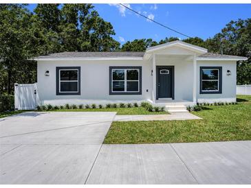 Charming single-story home with a freshly painted exterior and meticulously manicured landscaping at 3016 N 73Rd St, Tampa, FL 33619