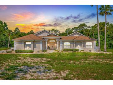 Beautiful single-story home featuring mature landscaping and a welcoming facade at sunset at 7206 River Country Dr, Weeki Wachee, FL 34607
