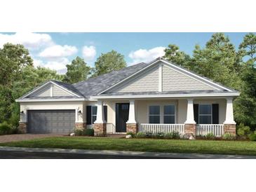 Charming single-story home with stone accents, well-manicured lawn, and a welcoming covered front porch at 11236 Kingly Ln, Odessa, FL 33556