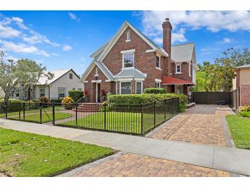 Charming brick two-story home featuring a manicured lawn and walkway at 126 14Th Ne Ave, St Petersburg, FL 33701
