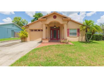 Charming single-story home with a red door and columns, plus a well-manicured front yard at 39055 9Th Ave, Zephyrhills, FL 33542