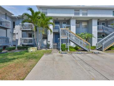 Attractive condo building with well-maintained landscaping and convenient parking at 4801 W Mcelroy Ave # D104, Tampa, FL 33611