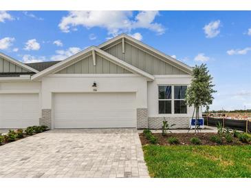 Charming single-story home featuring a two-car garage, attractive landscaping, and a welcoming brick driveway at 755 Maldives Trl, Sarasota, FL 34234