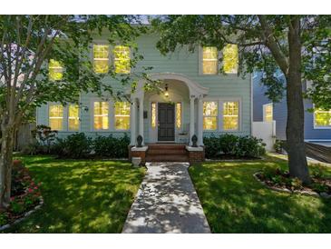 Charming two-story home featuring a well-manicured lawn and inviting front porch at 834 26Th N Ave, St Petersburg, FL 33704