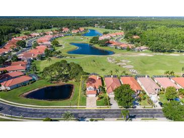 Beautiful aerial view of home, golf course, and ponds in a scenic residential neighborhood at 1228 Dartford Dr, Tarpon Springs, FL 34688