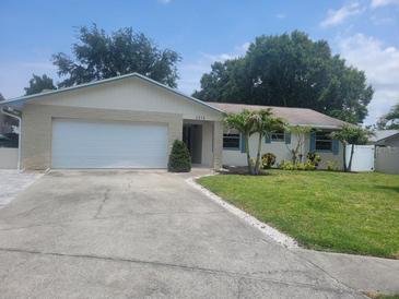 Charming single-story home with a well-manicured front yard and attached two-car garage at 2278 Republic Dr, Dunedin, FL 34698