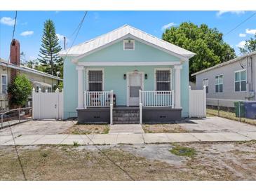 Charming bungalow with light blue exterior, white trim, and inviting front porch at 2306 W Ivy St, Tampa, FL 33607