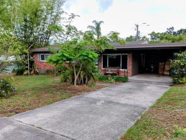 Charming single-story brick home with a well-maintained lawn and mature trees at 307 Druid Hills Rd, Temple Terrace, FL 33617