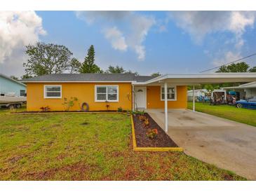 Charming single-story home with a well-maintained lawn and a covered carport at 404 12Th Sw St, Ruskin, FL 33570