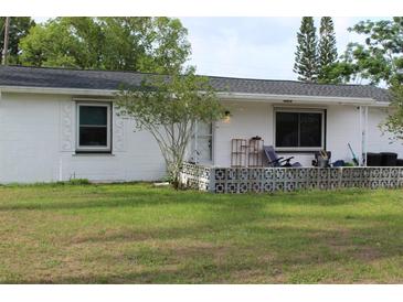 Charming single-story home with a well-manicured lawn and a quaint, fenced-in front porch for relaxing at 4928 Lake Ridge Ln, Holiday, FL 34690