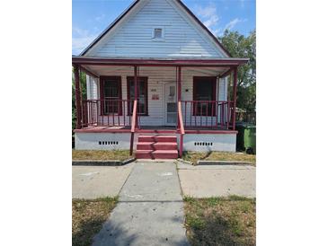 Charming home with a covered porch and red accents at 1935 W Union St, Tampa, FL 33607