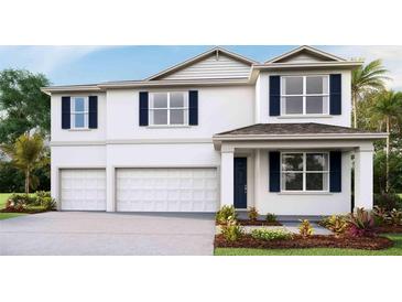 Charming two-story home featuring a two-car garage, well-maintained landscaping and inviting entryway at 2245 Sienna Spruce St, Wesley Chapel, FL 33543