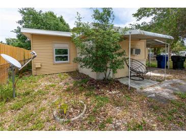 View of the backyard patio with mature landscaping, providing a relaxing outdoor space at 1144 7Th Nw St, Largo, FL 33770