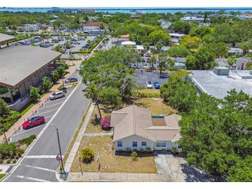 An aerial view showcases this cozy residence nestled in a vibrant neighborhood close to local amenities and waterfront views at 556 Virginia St, Dunedin, FL 34698