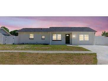 Charming one-story home with a well-manicured lawn, freshly painted exterior, and a new roof at 6110 16Th St, Zephyrhills, FL 33542