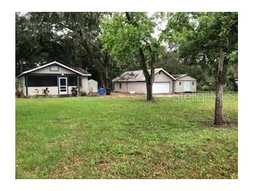 Charming single-story home with a well-maintained lawn and a detached garage at 118 W 122Nd Ave, Tampa, FL 33612