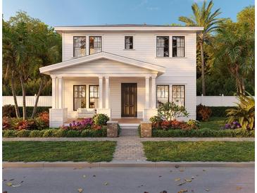 Charming two-story home featuring a welcoming front porch with columns and beautifully landscaped yard at 1435 17Th N Ave, St Petersburg, FL 33704