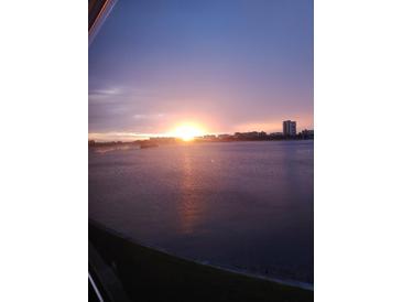 Beautiful sunset view over the water with a city skyline in the background at 1898 Shore S Dr # 311, South Pasadena, FL 33707