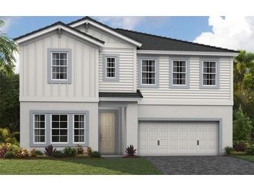 Charming two-story home with a two-car garage, well-manicured lawn, and traditional architectural details at 3814 Farm Garden Ct, Bradenton, FL 34211