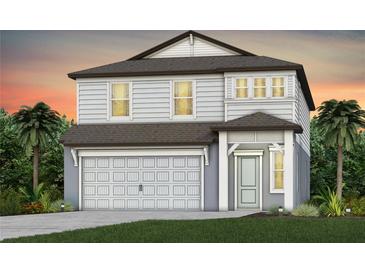 Two-story home featuring a covered entryway, and a two-car garage, set against a stunning sunset backdrop at 4205 Goldfoil Rd, Spring Hill, FL 34609