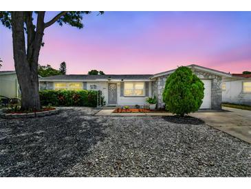 Charming single-story home with stone accents and a well-maintained front yard at 1150 Grand Blvd, Holiday, FL 34690