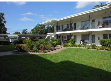 Charming two-story condo complex with iron railings and landscaped courtyard at 138 36Th N Ave # 206W, St Petersburg, FL 33704