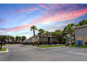 Exterior view of the apartment building with trees, sidewalk and reserved parking space at 213 Red Cedar Pl # 213, Brandon, FL 33510