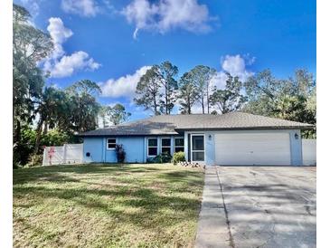 Charming single-story home featuring a two-car garage and a well-maintained front yard at 2841 S Cranberry Blvd, North Port, FL 34286