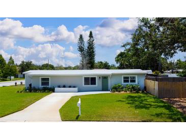 Charming single-story home featuring a well-manicured lawn, vibrant plants and a white mailbox and drive way at 3951 72Nd N St, St Petersburg, FL 33709