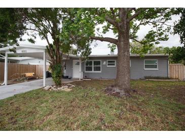 Charming single-story home with a covered carport and well-maintained front yard and mature trees at 5205 98Th N Ter, Pinellas Park, FL 33782