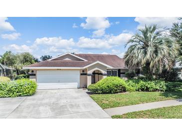 Charming single Gathering home featuring a well maintained lawn and a two car garage at 6436 Huntington Dr, Zephyrhills, FL 33542