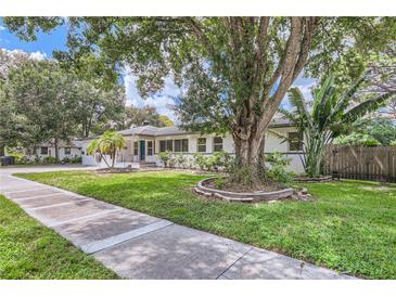 Charming single-story home with lush landscaping, mature trees, and a well-manicured lawn at 1145 53Rd N Ave, St Petersburg, FL 33703