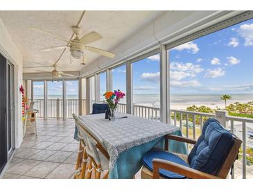 Relax on this balcony overlooking the beach with tile floors, ceiling fan and balcony furniture at 17980 Gulf Blvd # 505, Redington Shores, FL 33708