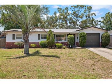 Charming single-story home with a well-maintained lawn, manicured shrubs and mature trees providing curb appeal at 2048 64Th S Ave, St Petersburg, FL 33712