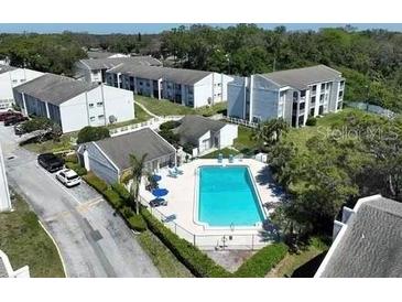 Scenic aerial view of the community featuring a refreshing pool and well-maintained apartment buildings at 2625 State Road 590 # 2832, Clearwater, FL 33759