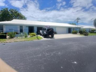 Charming single story home featuring lush landscaping, a private driveway, and an attached garage at 804 67Th W St, Bradenton, FL 34209