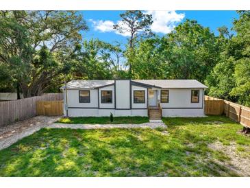 Charming single-story home with well-maintained lawn and natural surroundings providing a serene and private setting at 9690 Jerome Dr, New Port Richey, FL 34654