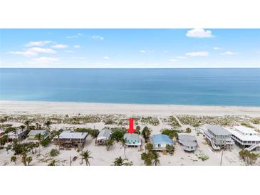 Charming beach house nestled on the pristine white sands with ocean views at 9760 Little Gasparilla Island, Placida, FL 33946