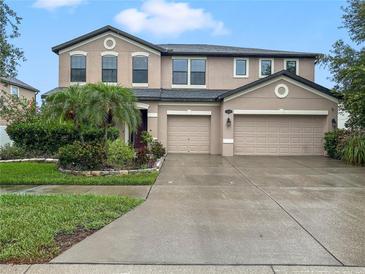 Charming two-story home with landscaped yard and a large two car garage and wide driveway at 11706 Gilmerton Dr, Riverview, FL 33579