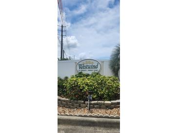 Westwind 55+ community sign with vibrant foliage at 3301 Alt 19 # 500, Palm Harbor, FL 34683