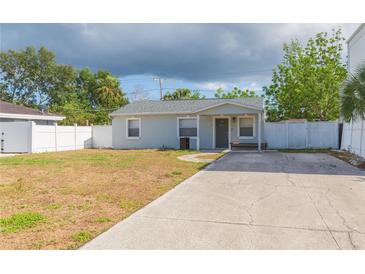 Charming single-story home with a well-maintained yard and a cozy front porch at 4714 W Lawn Ave, Tampa, FL 33611