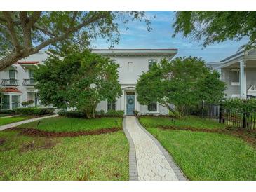 Charming two-story home with a well-manicured front yard and inviting walkway to a blue front door at 5015 S Elberon St, Tampa, FL 33611