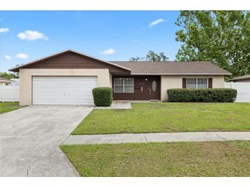 Charming one-story home with a well-maintained lawn and attached one car garage at 5213 Burr Pl, Seffner, FL 33584