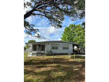 Charming single-story home with a well-maintained lawn and beautiful, mature landscaping at 6099 107Th N Ave, Pinellas Park, FL 33782